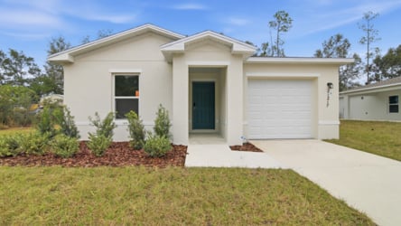 A white house with a garage.