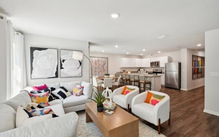 A living room with a wood floor.