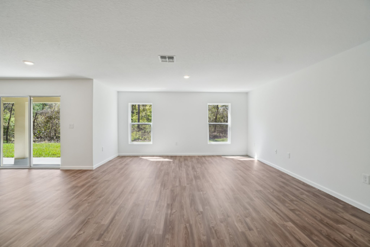A room with a wood floor and windows.