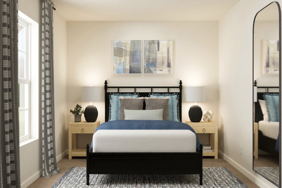 A bedroom with a bed and a mirror.