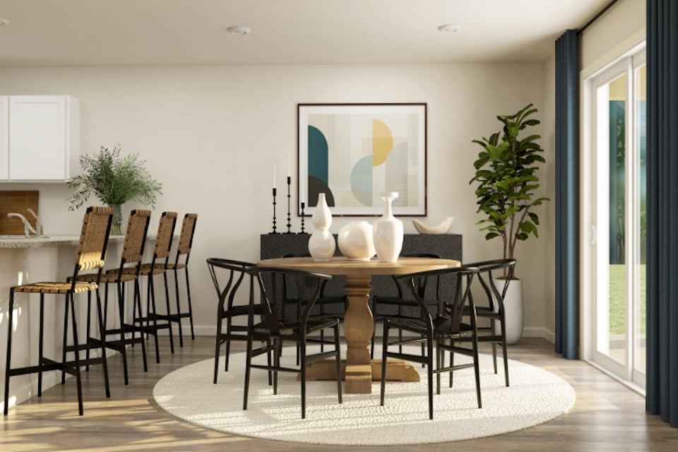 A dining room with a table and chairs.