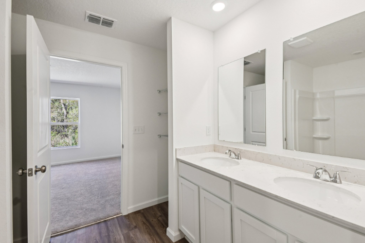 A bathroom with a large mirror.