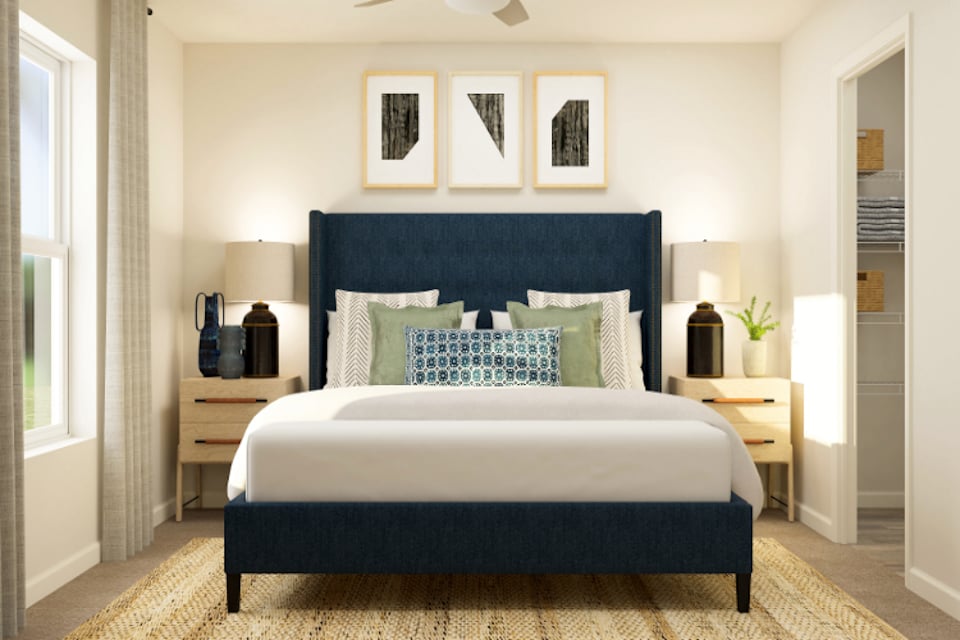 A bedroom with a bed and a desk.