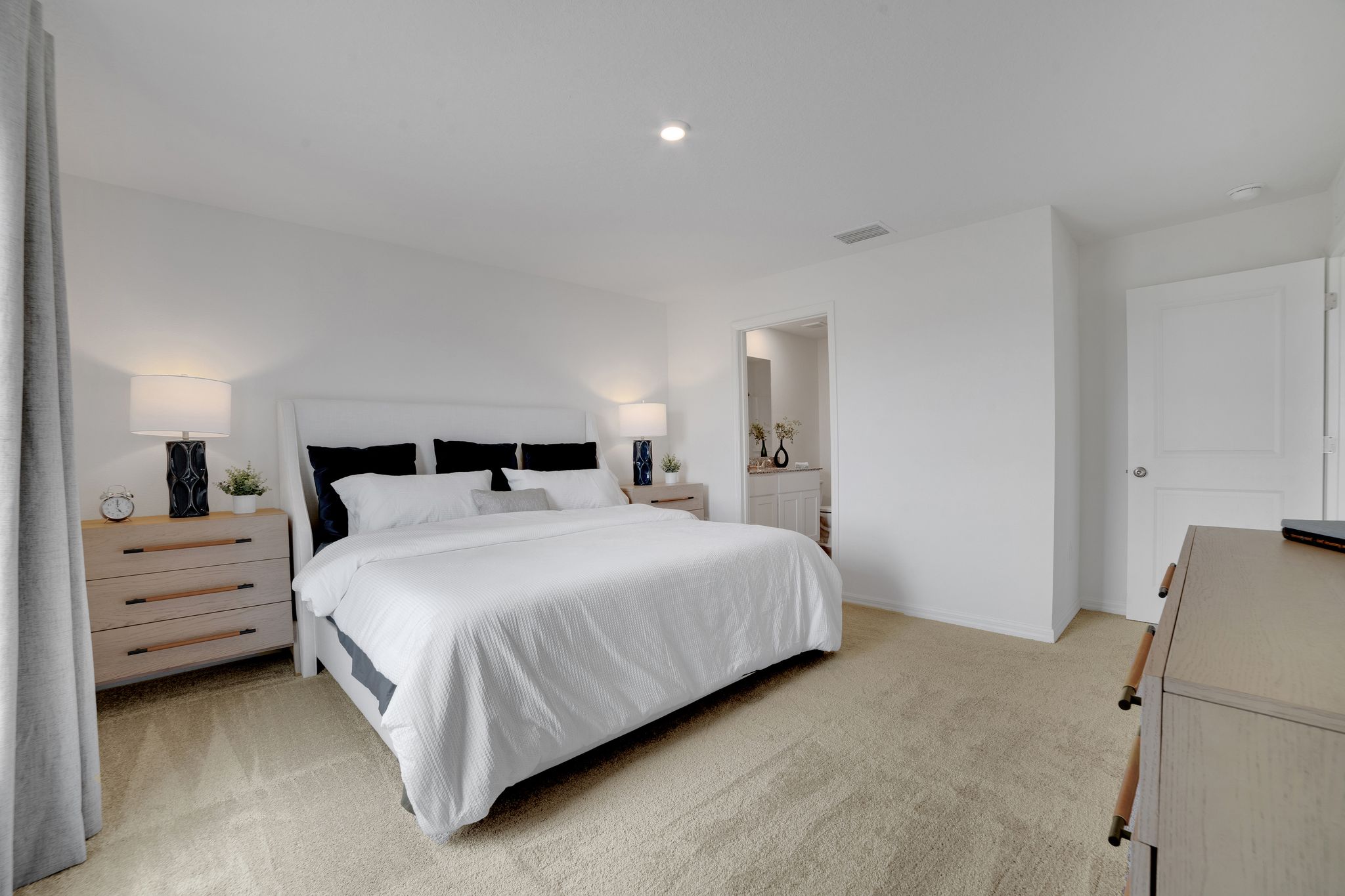 A bedroom with a bed and a dresser.