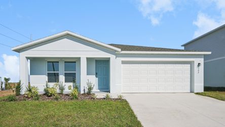 A white house with a garage.