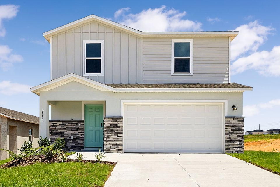 A white house with a garage.