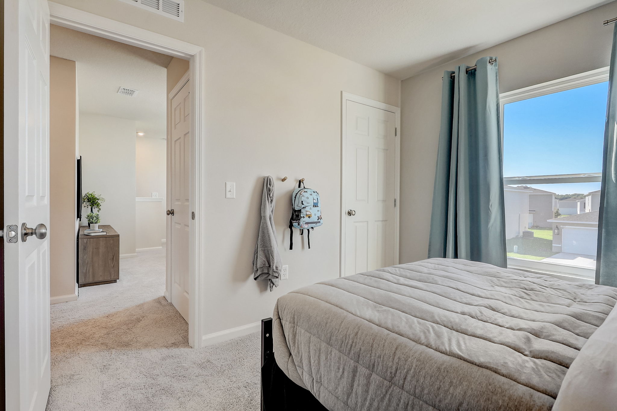 A bedroom with a large window.