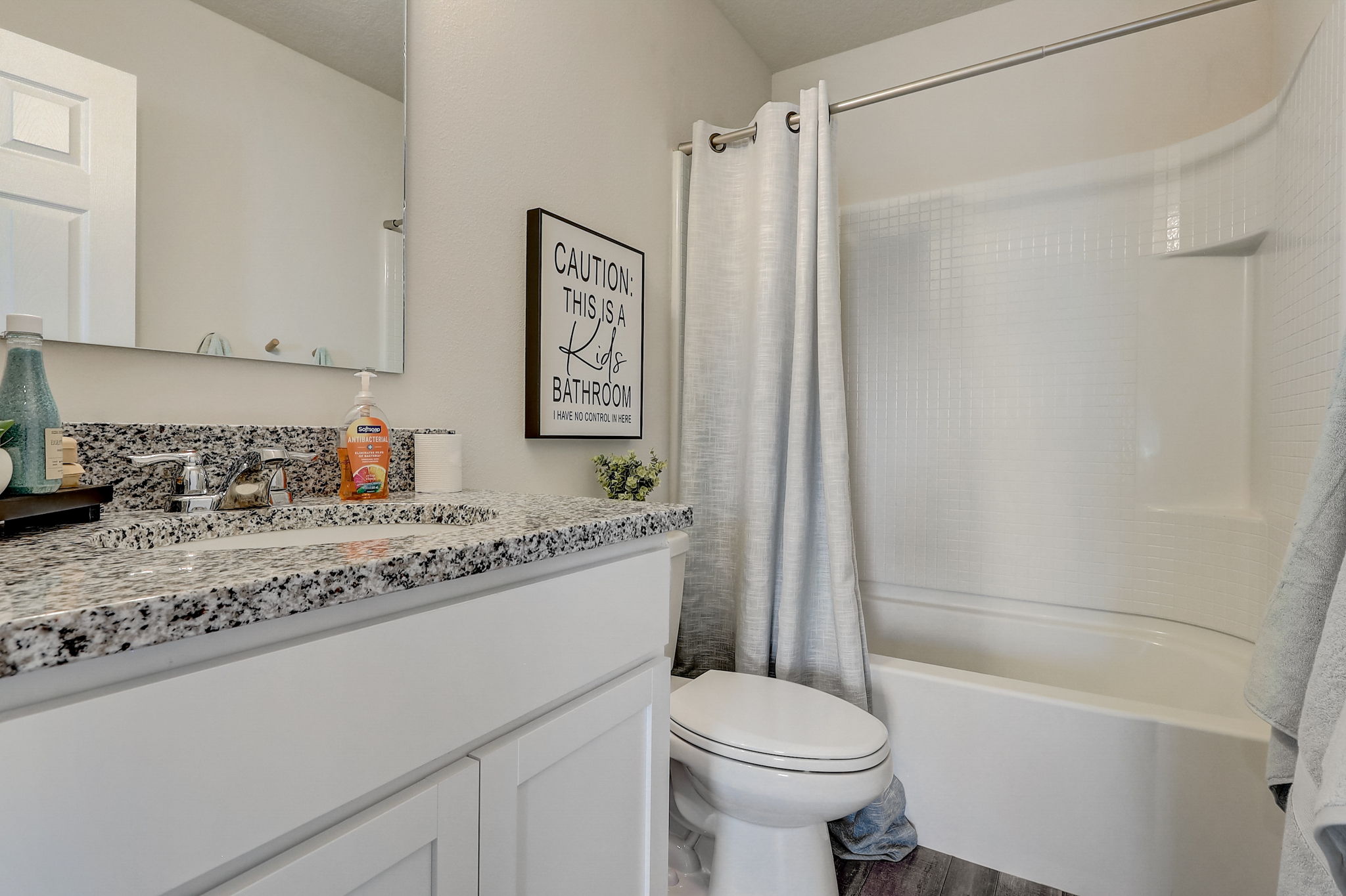 A bathroom with a tub sink and toilet.