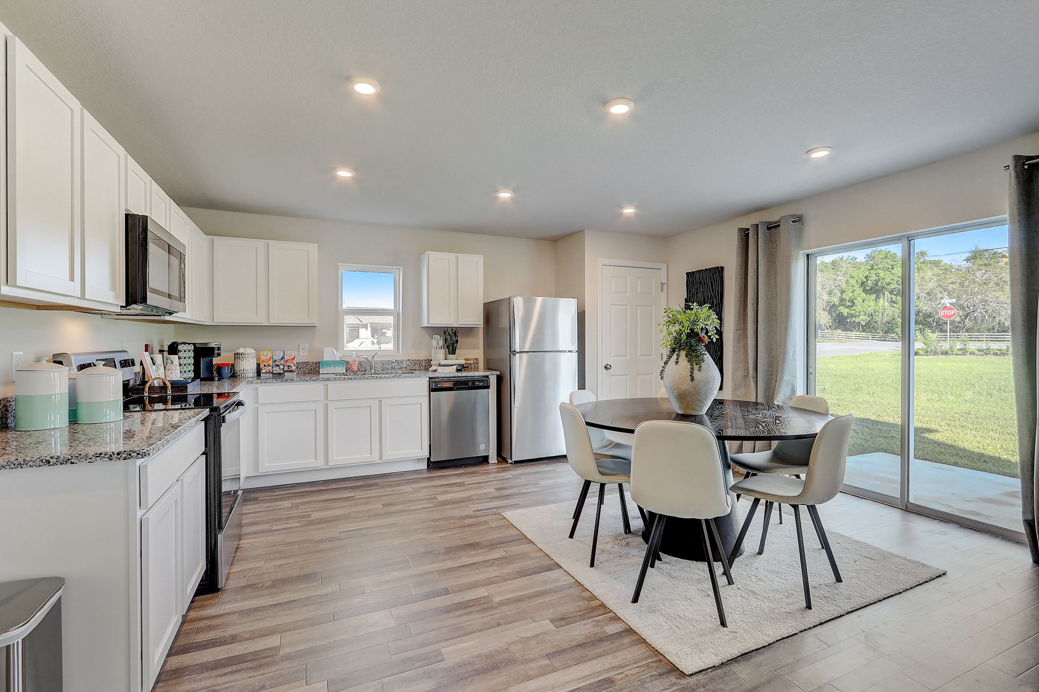 A kitchen with a dining table and chairs.