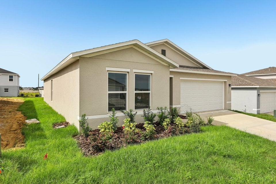 A house with a garage and a lawn.