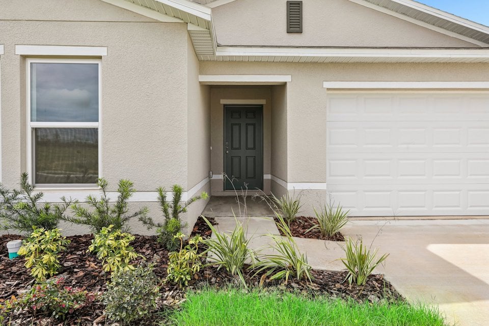 A house with a garage and a door.