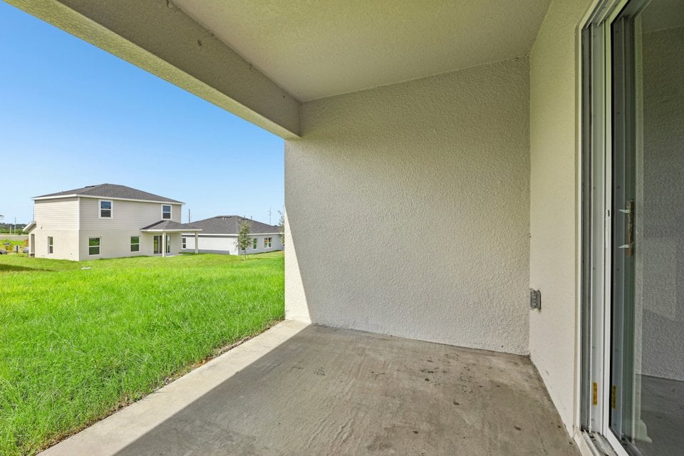 A building with grass and a walkway.