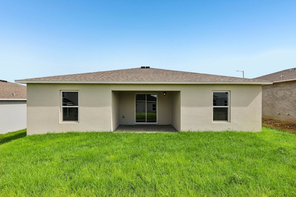 A house with a grass yard.