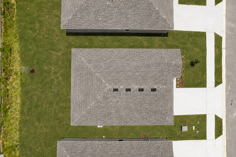 A rectangular grey object on a green field.