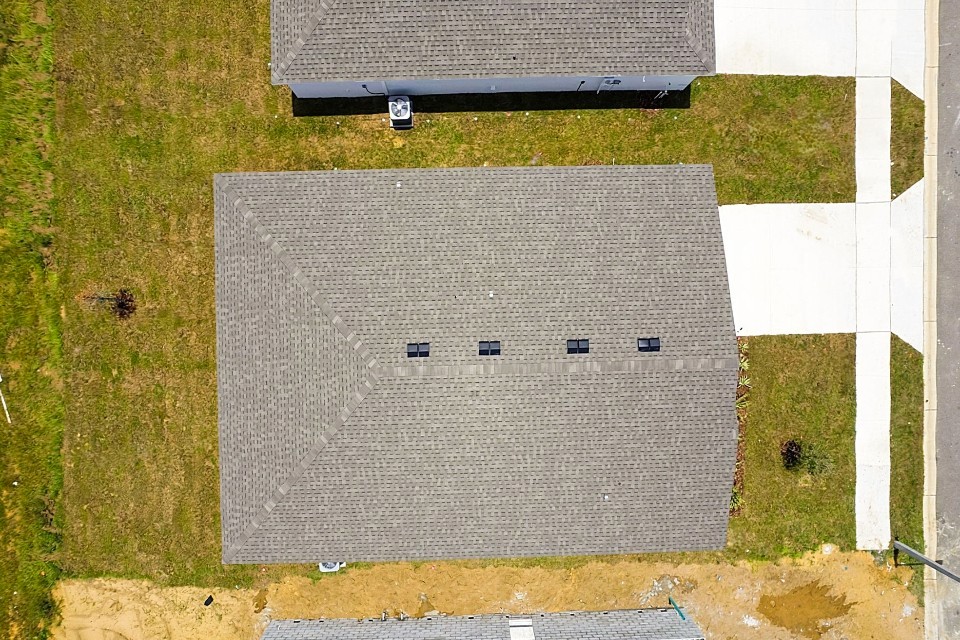A rectangular grey object on a green surface.
