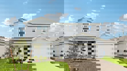 A white house with a driveway.