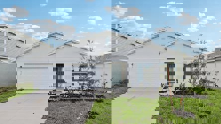 A white house with a driveway.