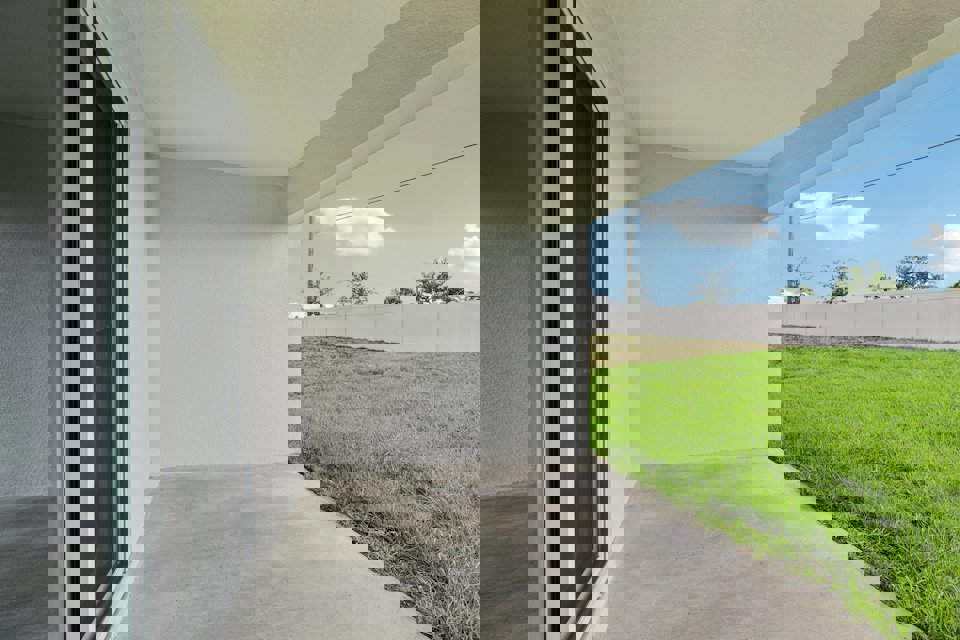 A building with grass and a walkway.