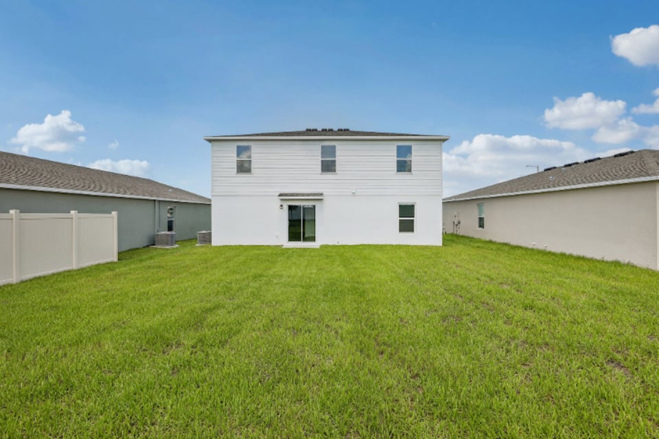 A group of buildings in a grassy field.