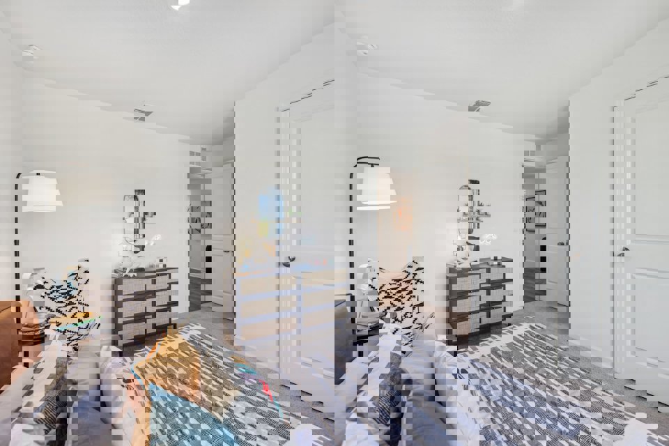 A living room with a rug and a couch.