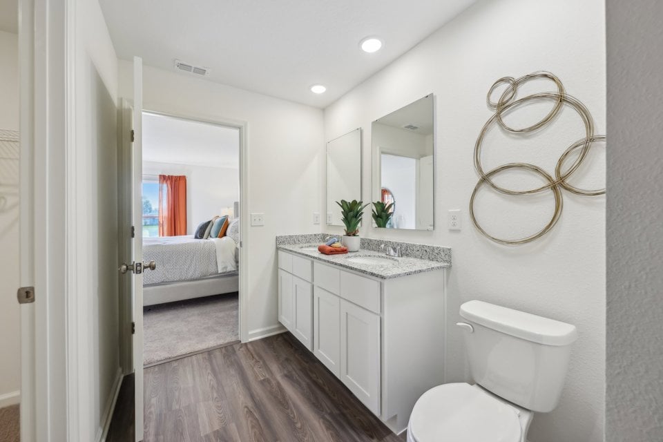A bathroom with a bed and a sink.