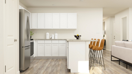 A kitchen with white cabinets.