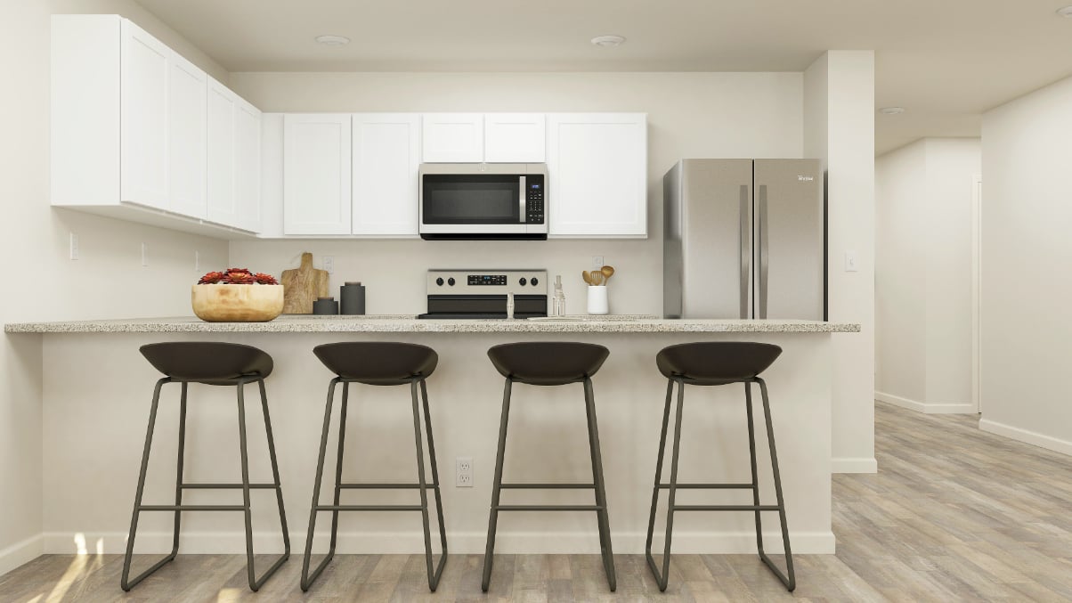 A kitchen with stools and a table.