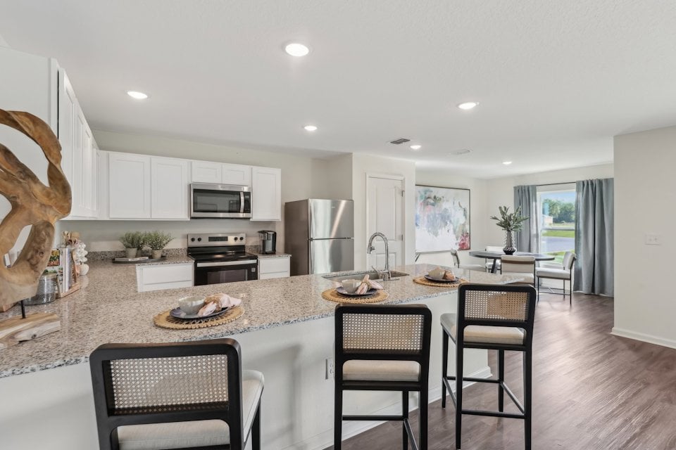 A kitchen with a marble island.