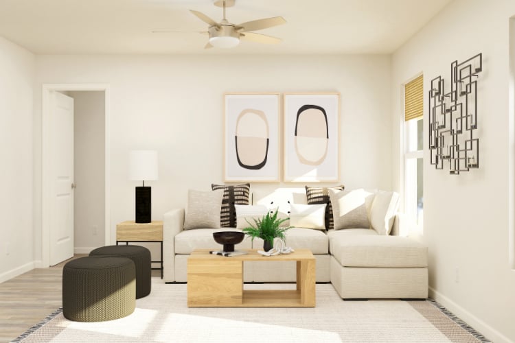 A living room with a white couch and a white ceiling fan.