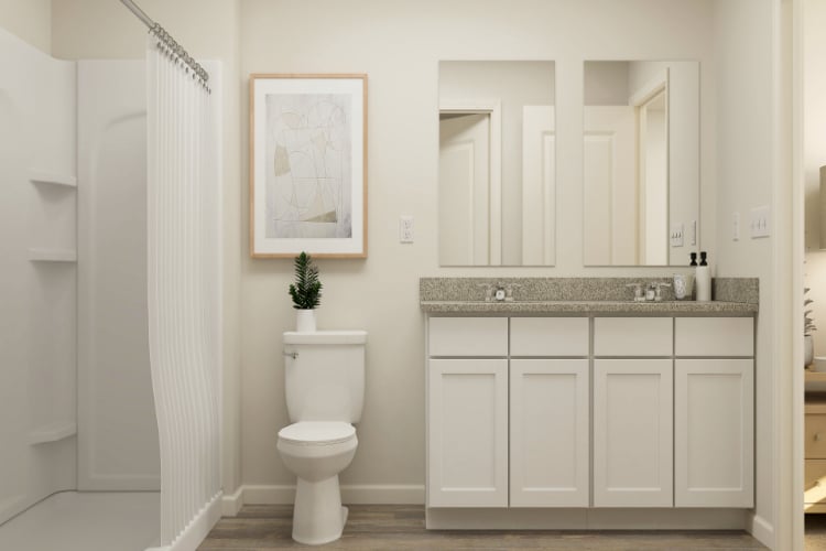 A bathroom with white cabinets.