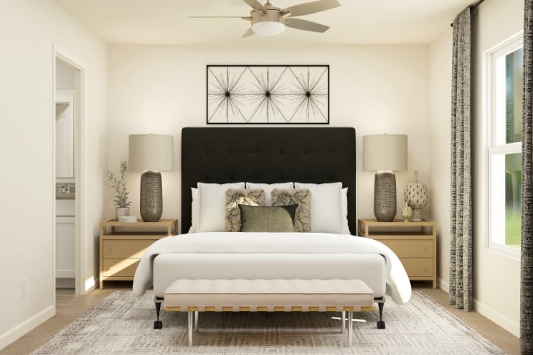 A bedroom with a bed and a table.