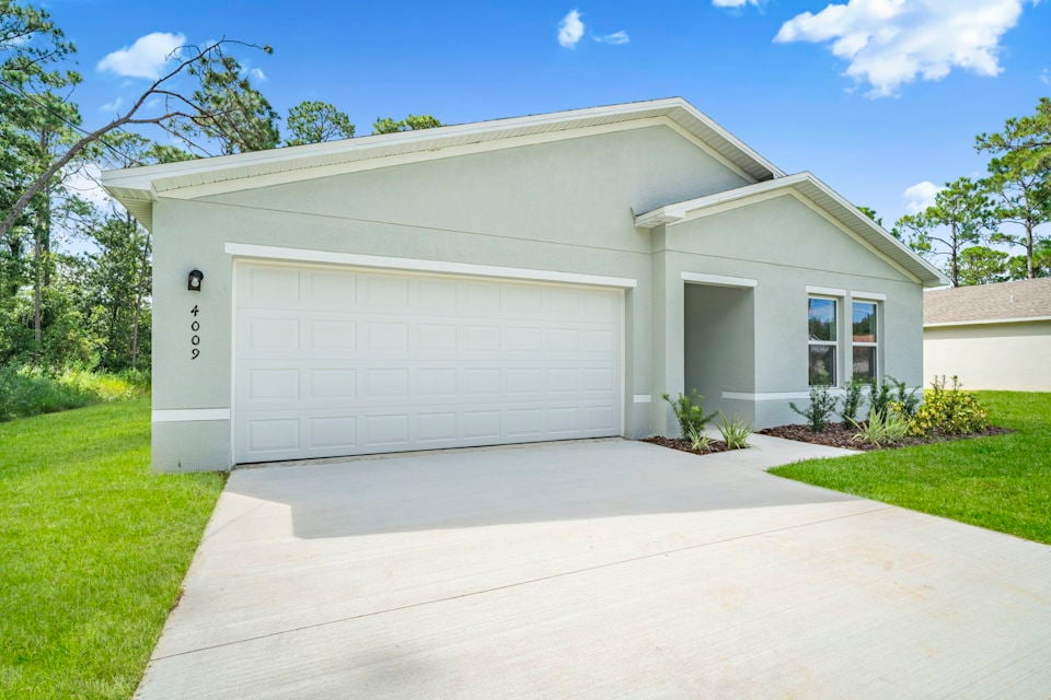A white garage with a driveway.