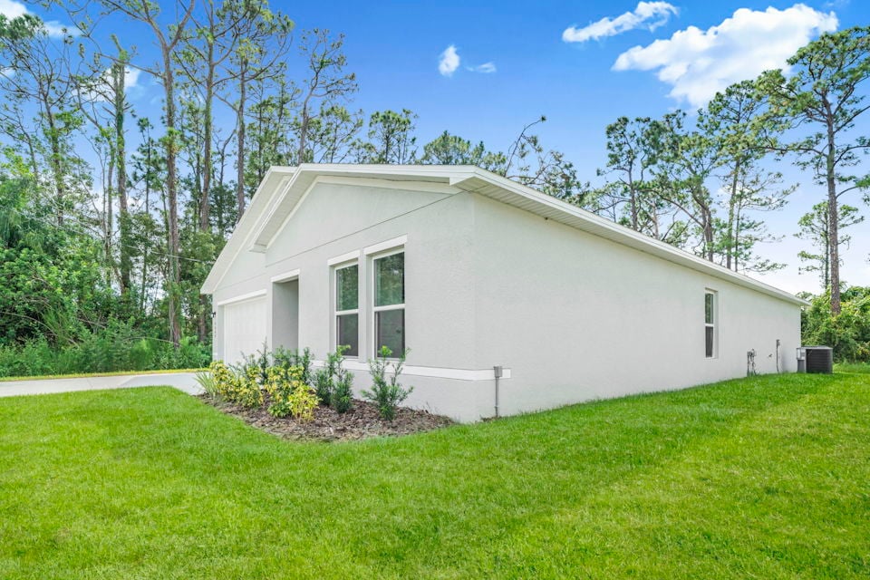 A white house with a lawn.