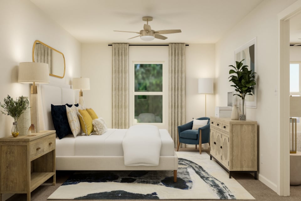 A living room with a white couch and a fan.