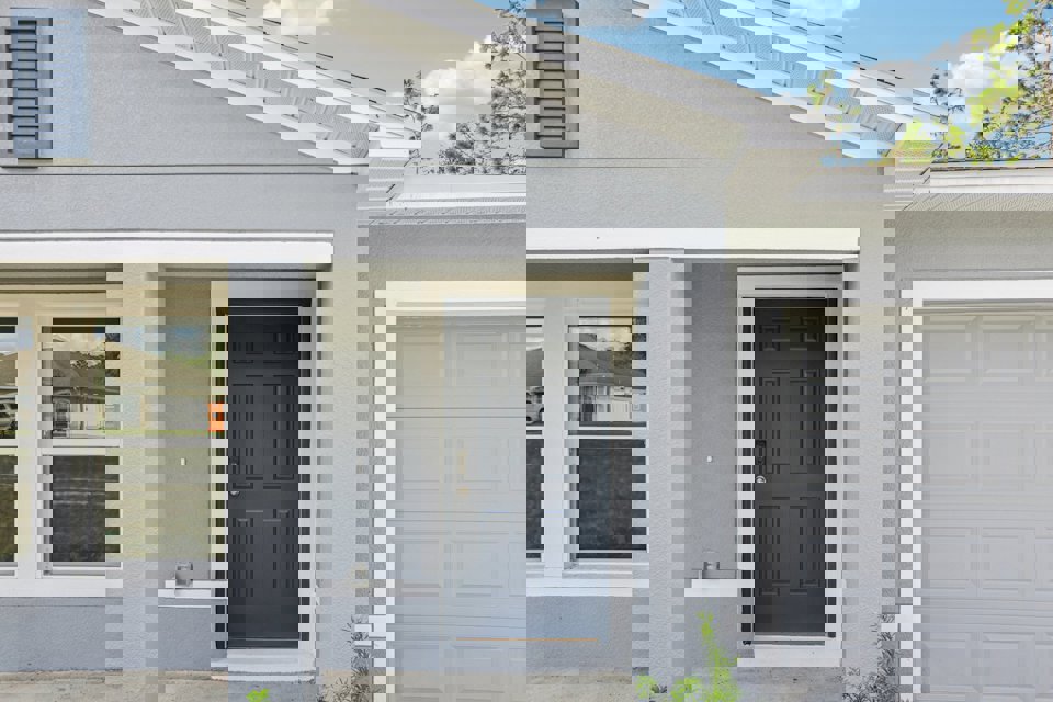 A white house with a black door.