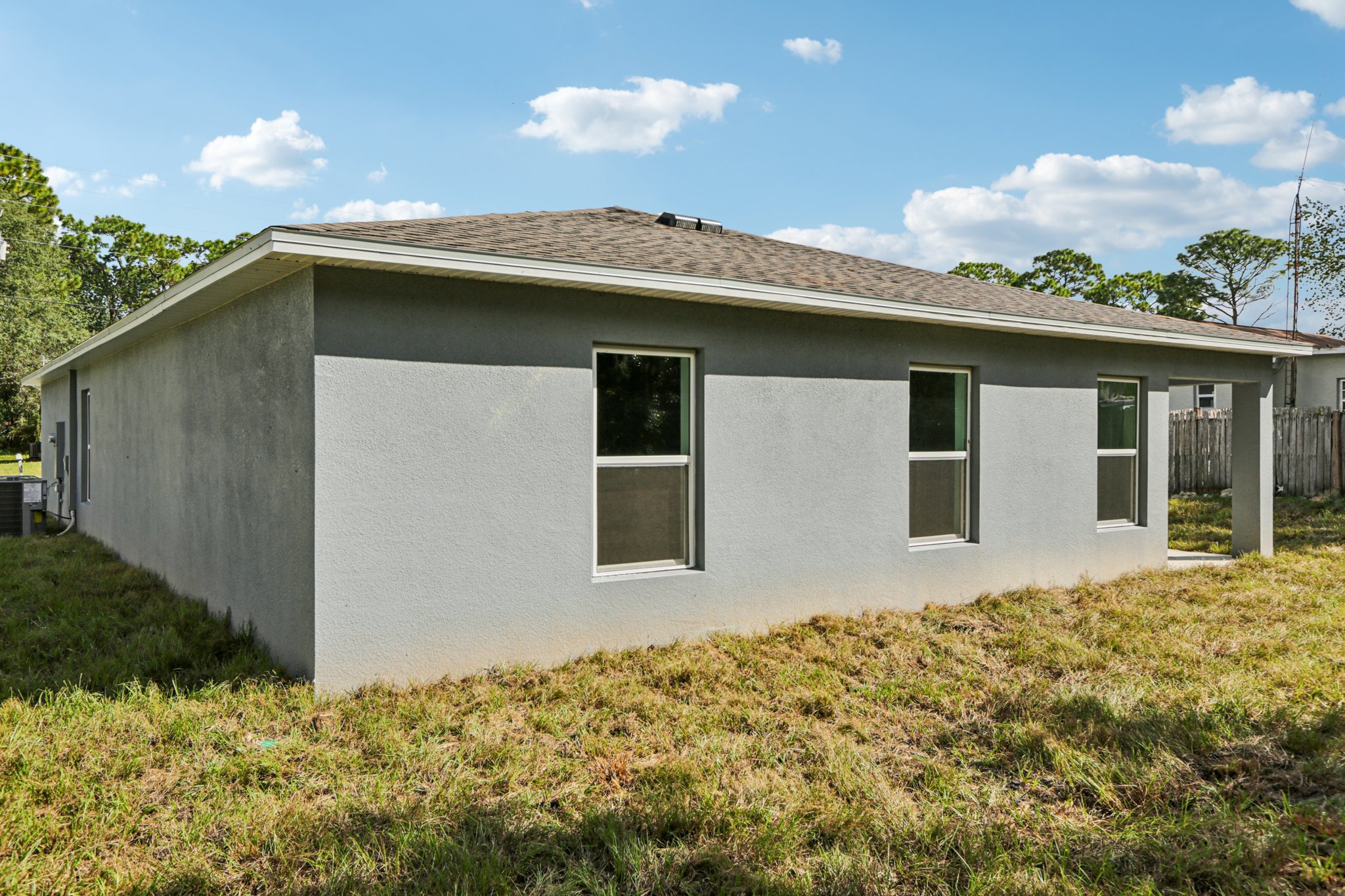 A white house with a fence.