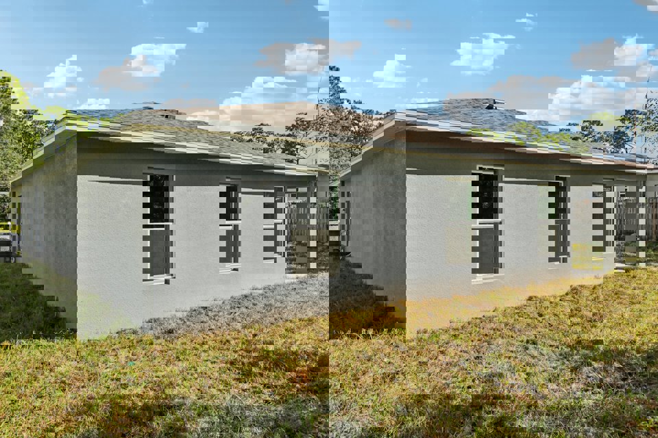 A white house with a fence.