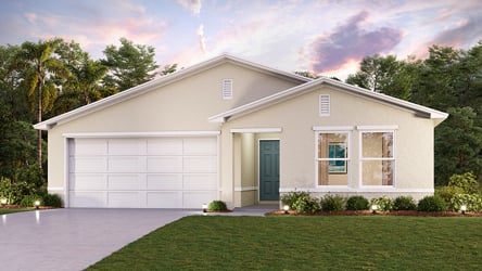 A white house with a lawn.