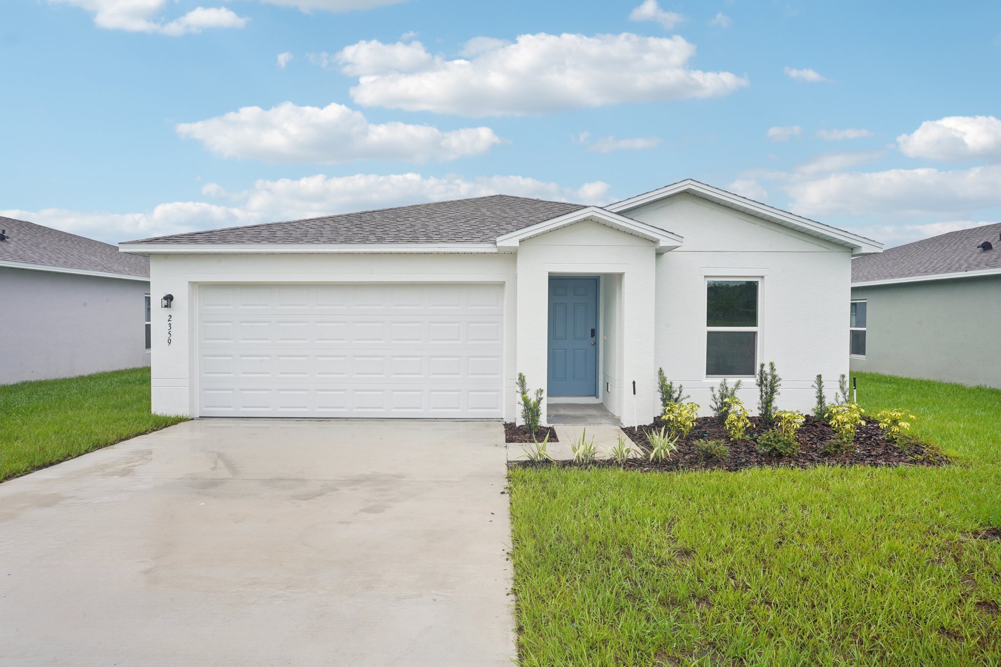 A white house with a garage.