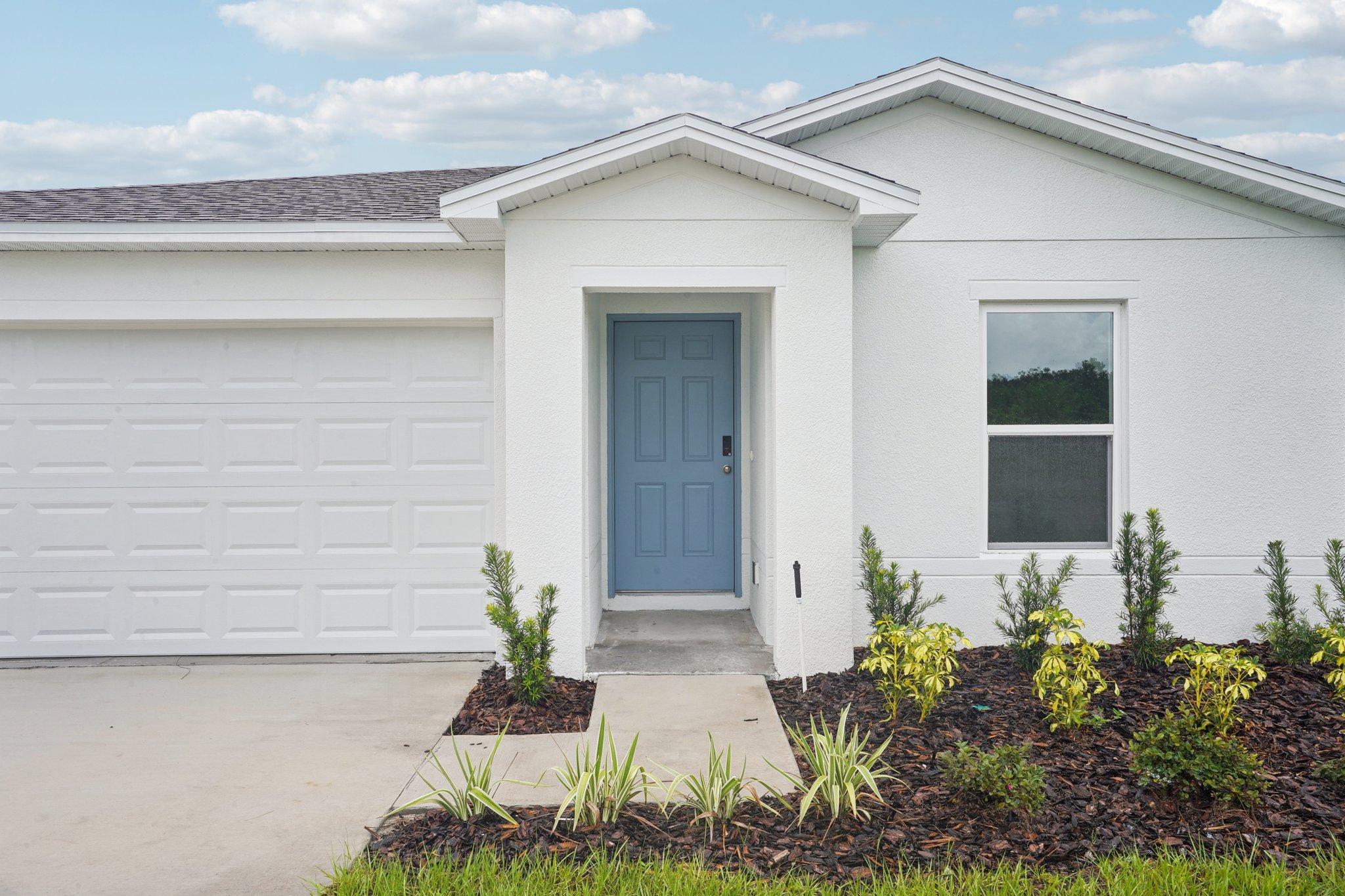 A white house with a blue door.