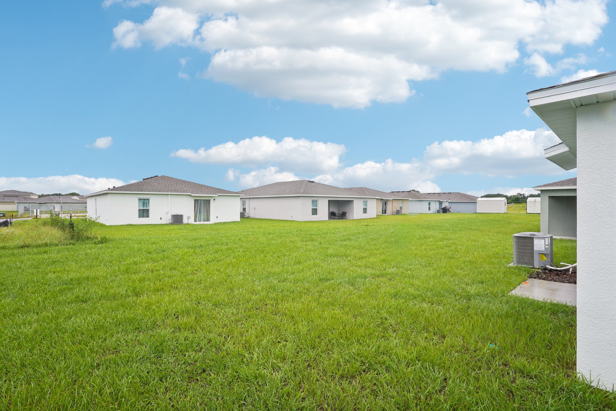A grassy area with buildings in the background.