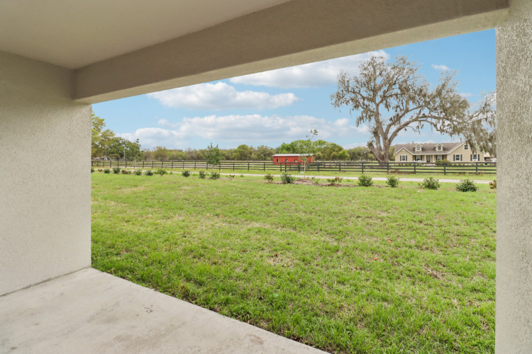 A grassy field with a building in the background.