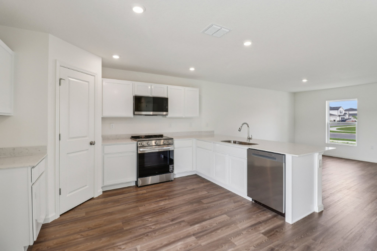 A kitchen with white cabinets.