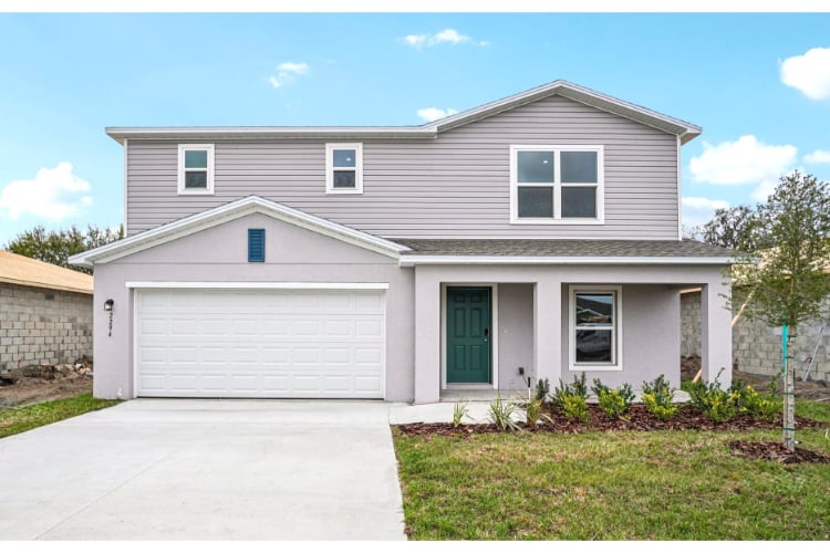 A white house with a garage.