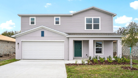 A white house with a garage.