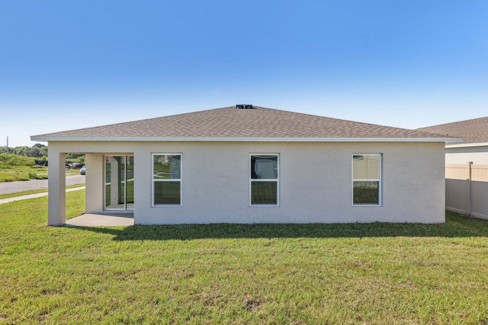 A house with a grass yard.