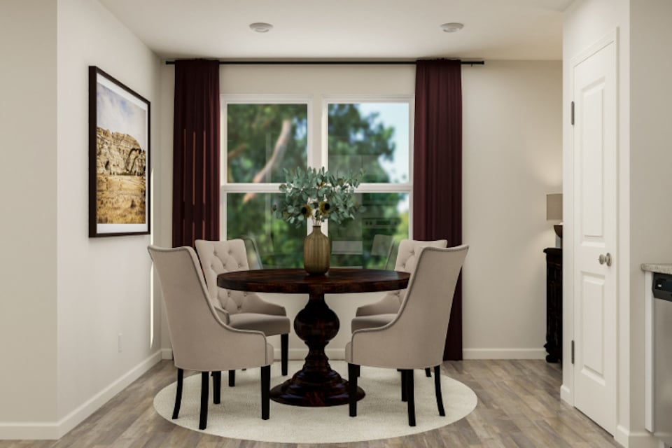 A dining room table with chairs.