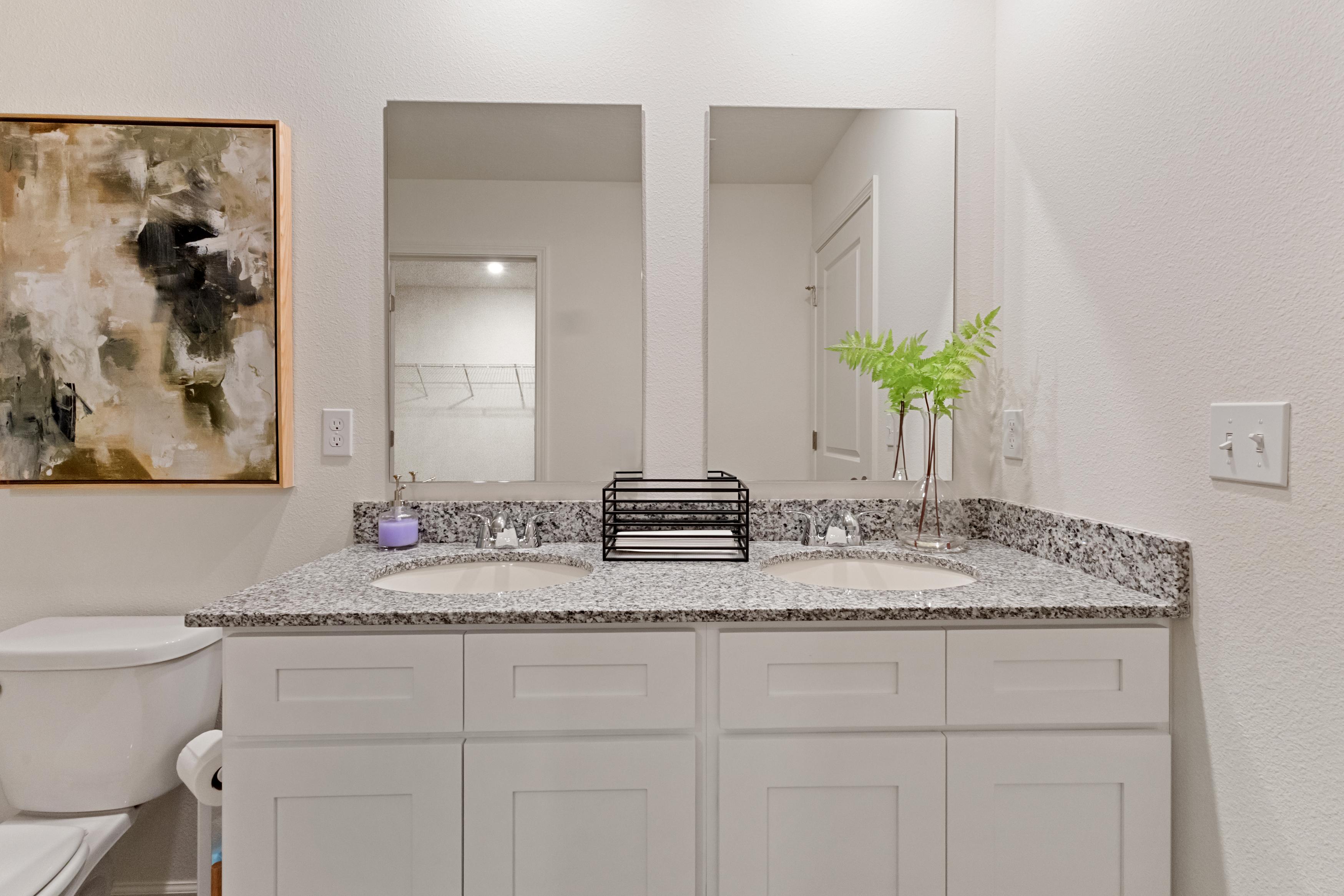 A bathroom with a marble countertop.