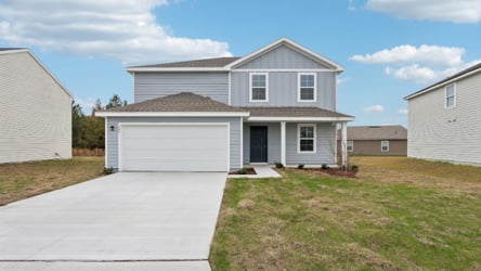 A house with garages and grass.