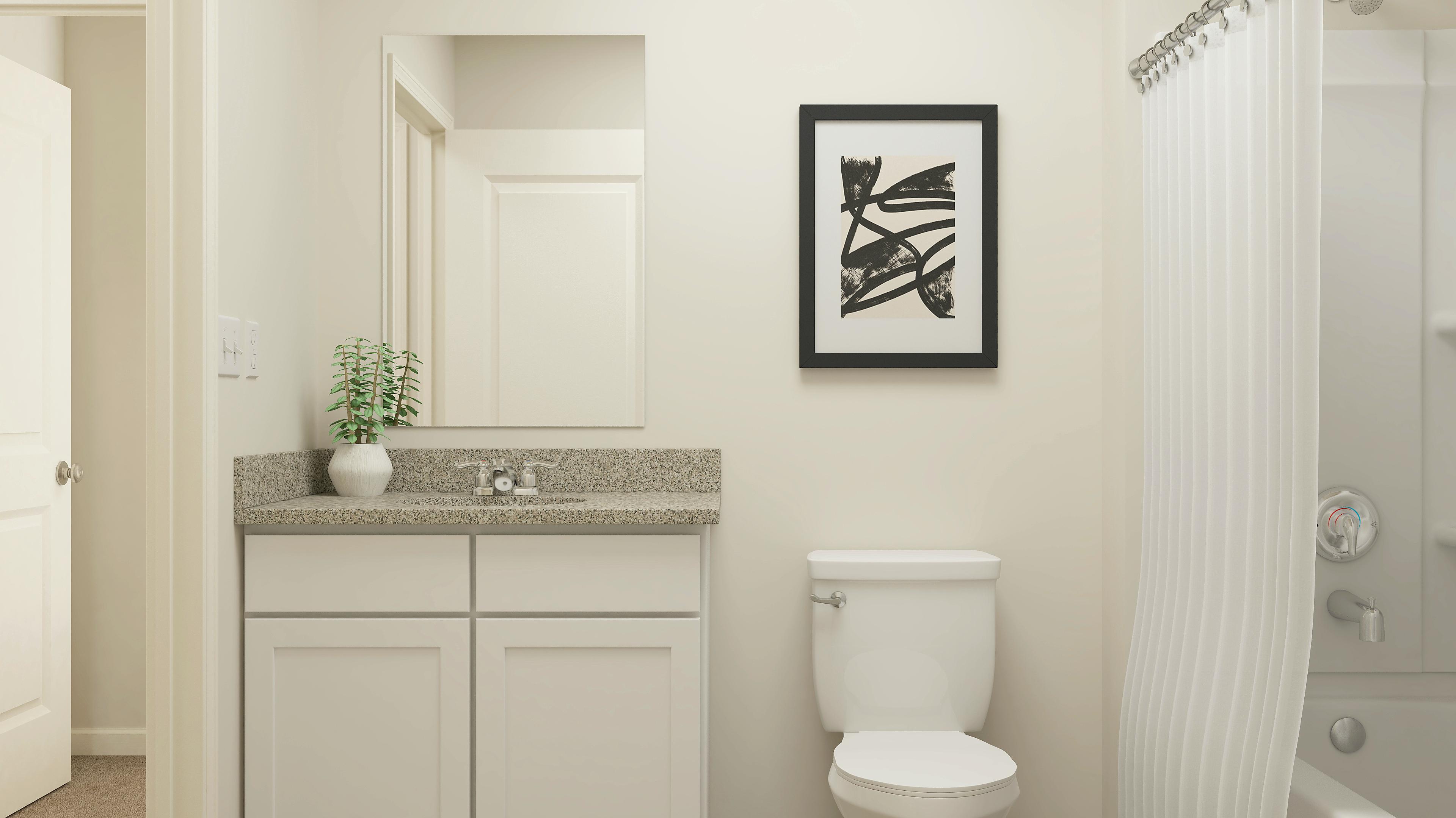 A bathroom with a sink toilet and a picture on the wall.